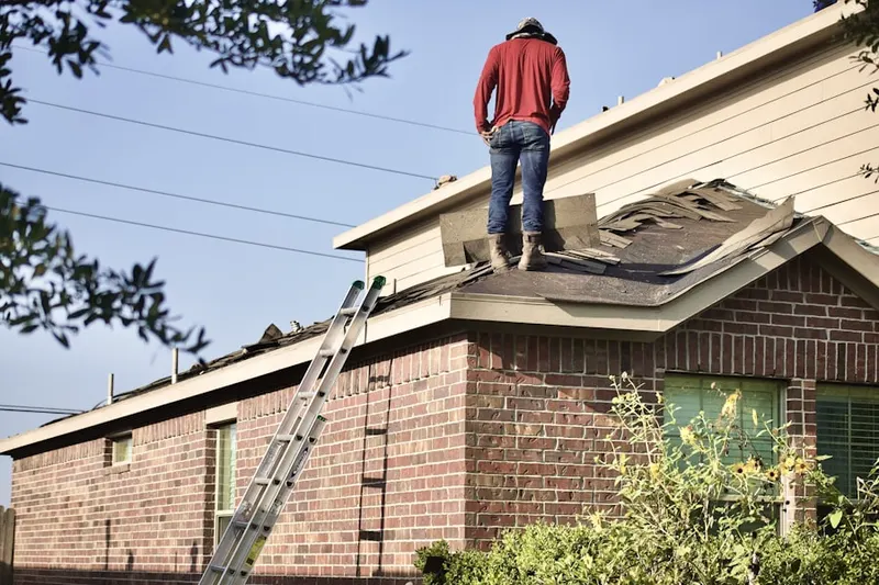 Professional roofer working on a residential roof in Struthers
